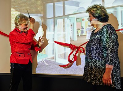 Angela Rippon cuts the ribbon at the Virtual Hospital opening watched by Professor June Andrews