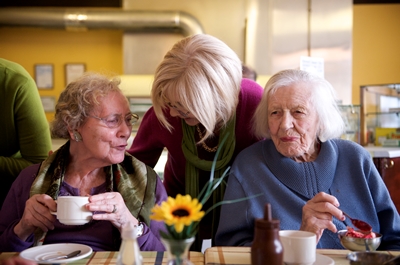 Two ladies enjoy a cup of tea in their local community