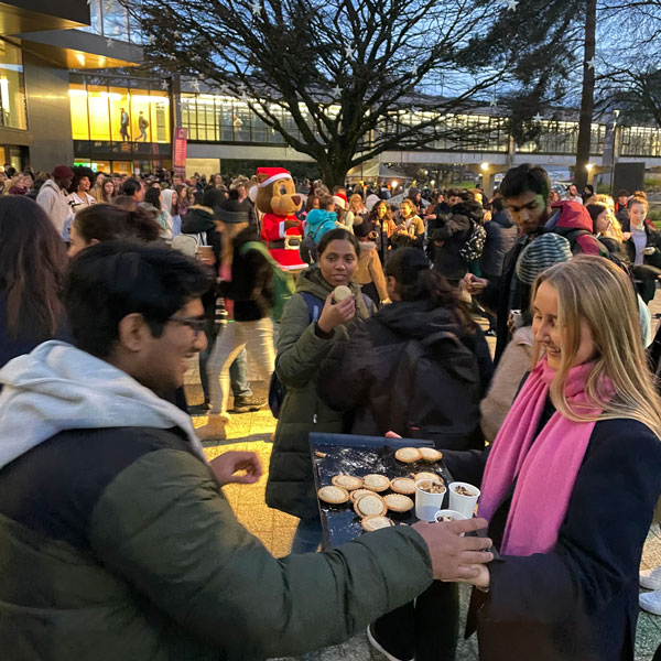 Queen's Court full of dancing people, helping themselves to free food