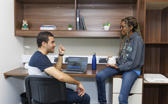 Students sitting in a room in University-managed accommodation