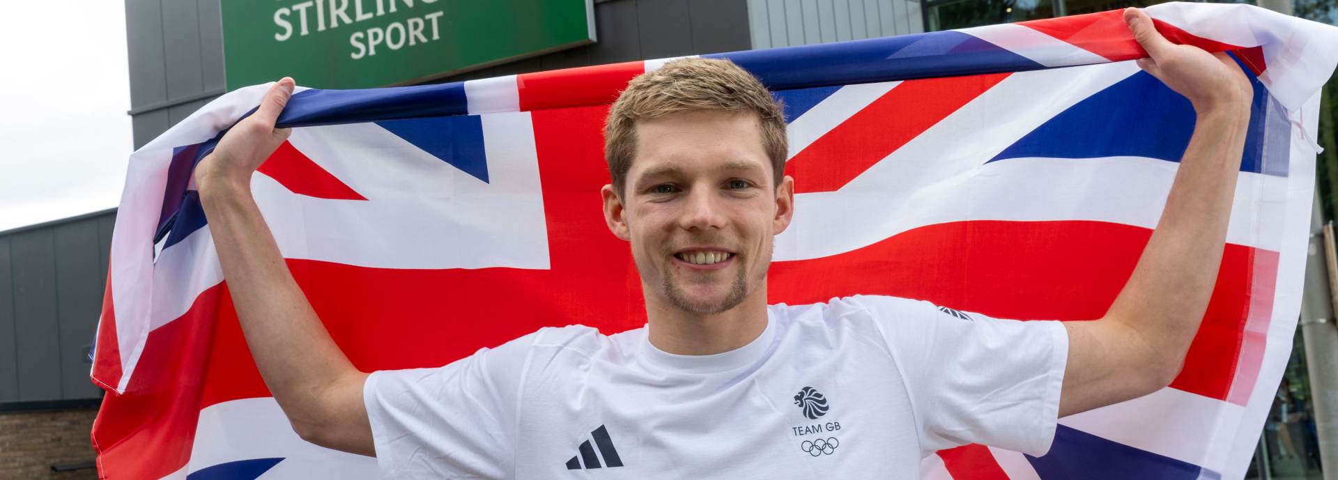 Duncan Scott poses with Union flag outside the University of Stirling.