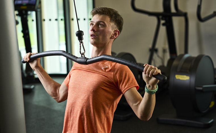 person using weights machine